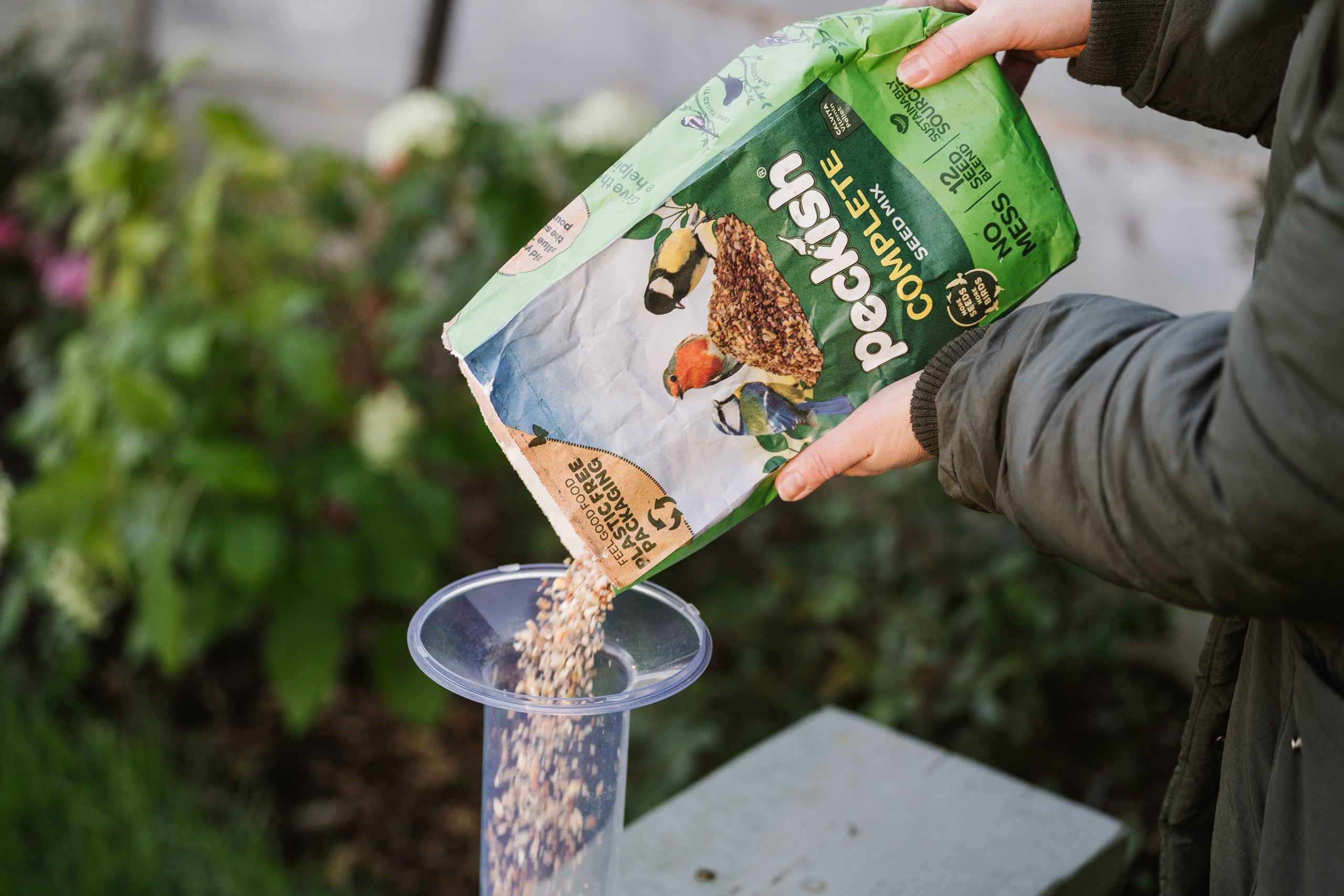 Peckish complete seed mix being poured into feeder